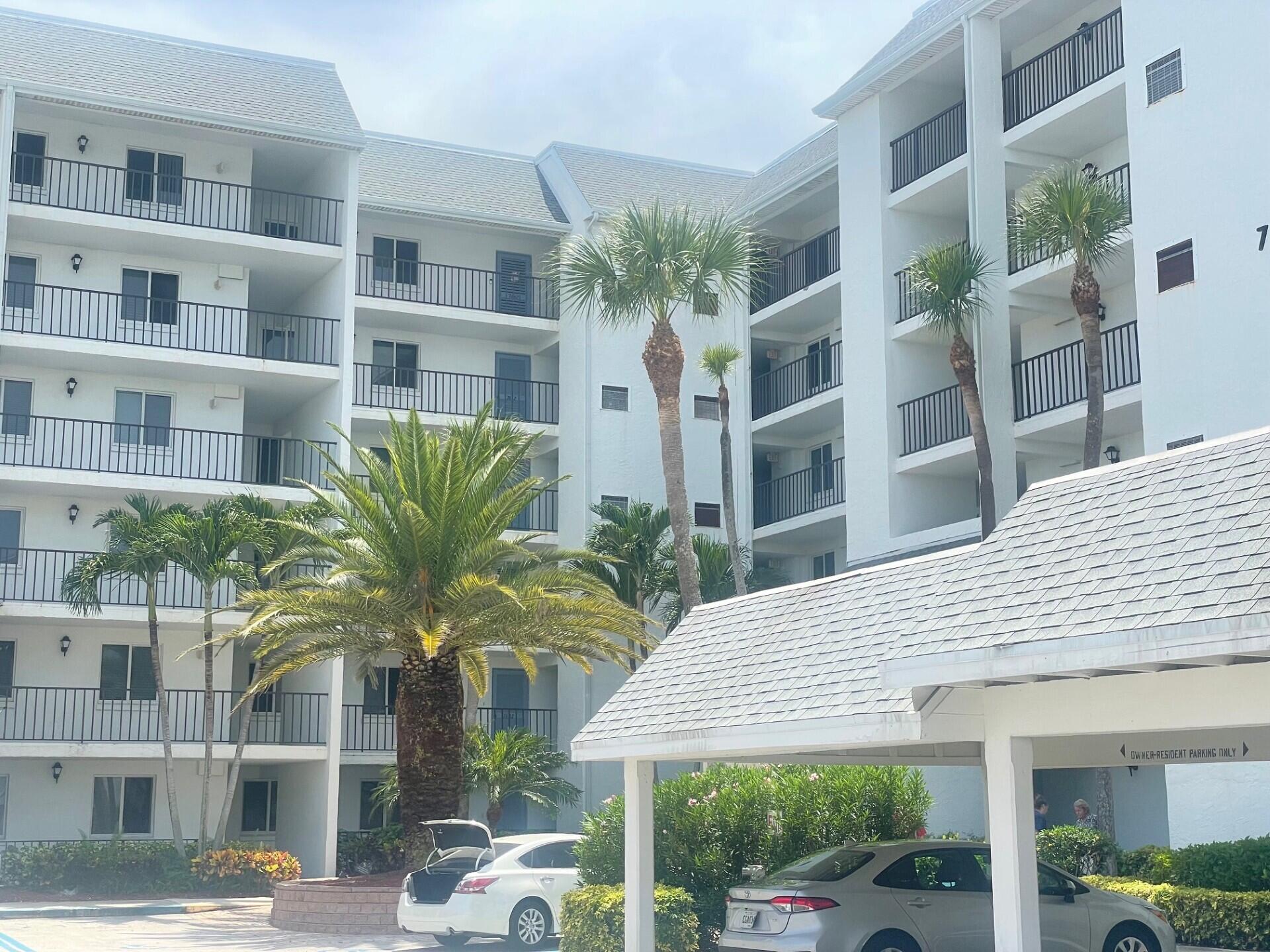 a front view of residential houses with palm trees