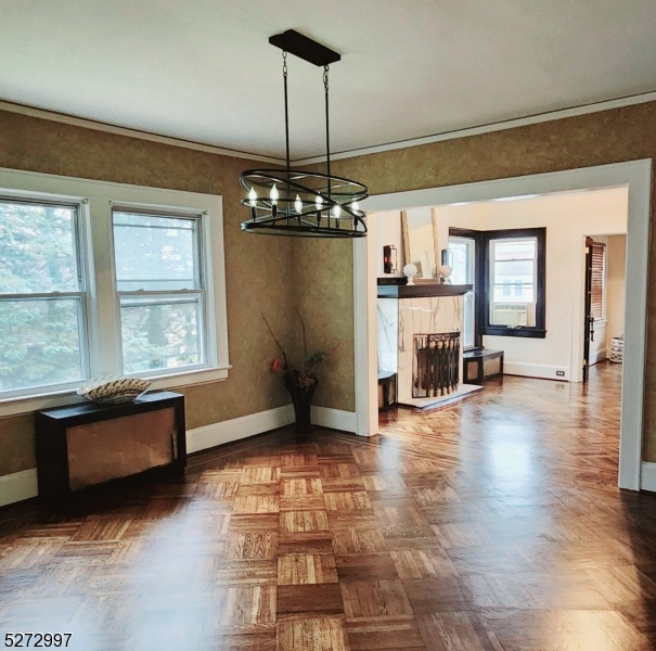 a view of a livingroom with wooden floor and a fireplace