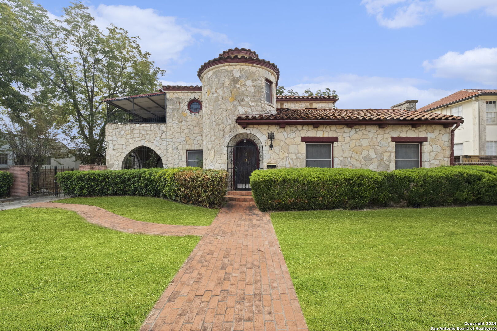 a front view of a house with garden