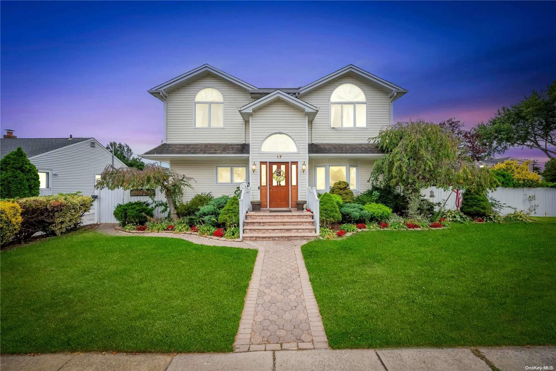 a front view of a house with a garden