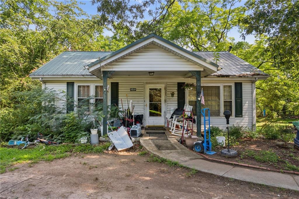 a front view of a house with a yard and porch