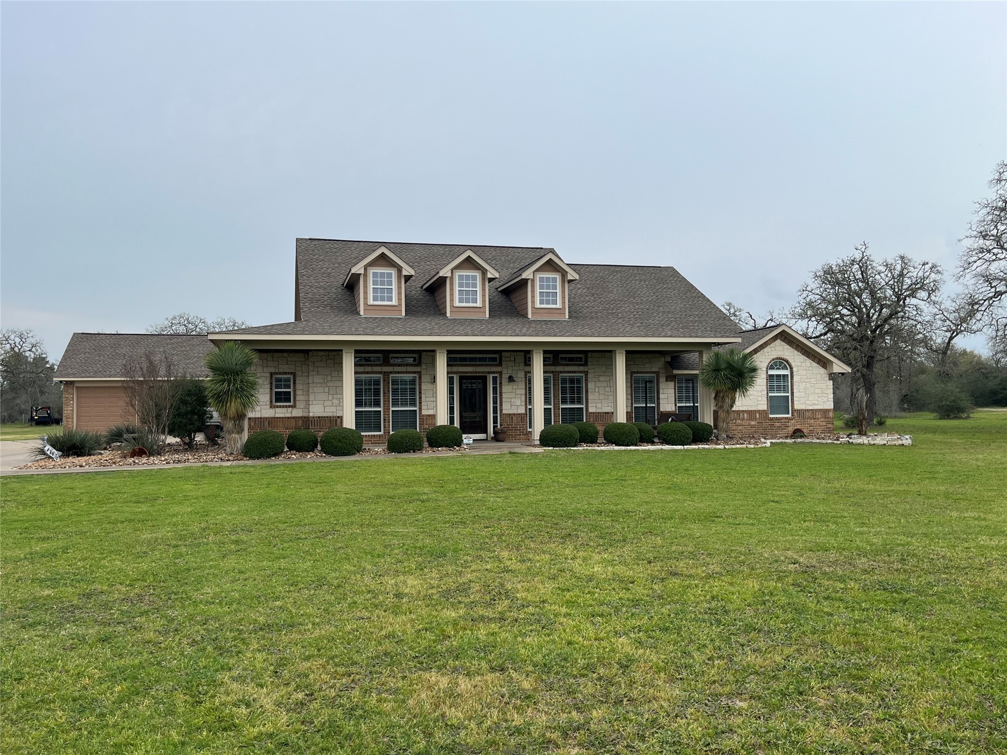 a front view of a house with a garden