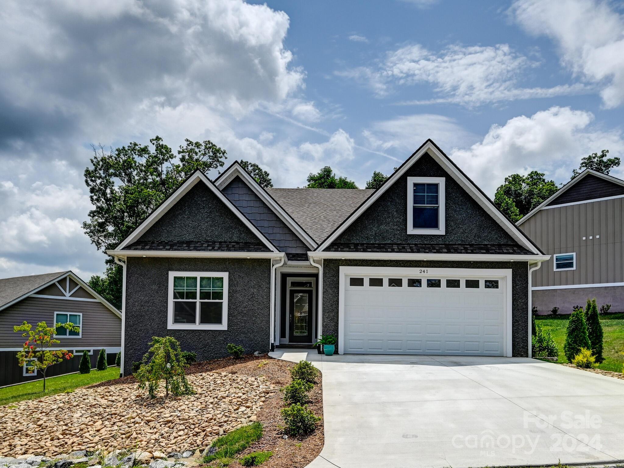 a front view of a house with garden