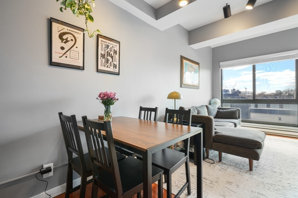 a view of a dining room with furniture large windows and wooden floor