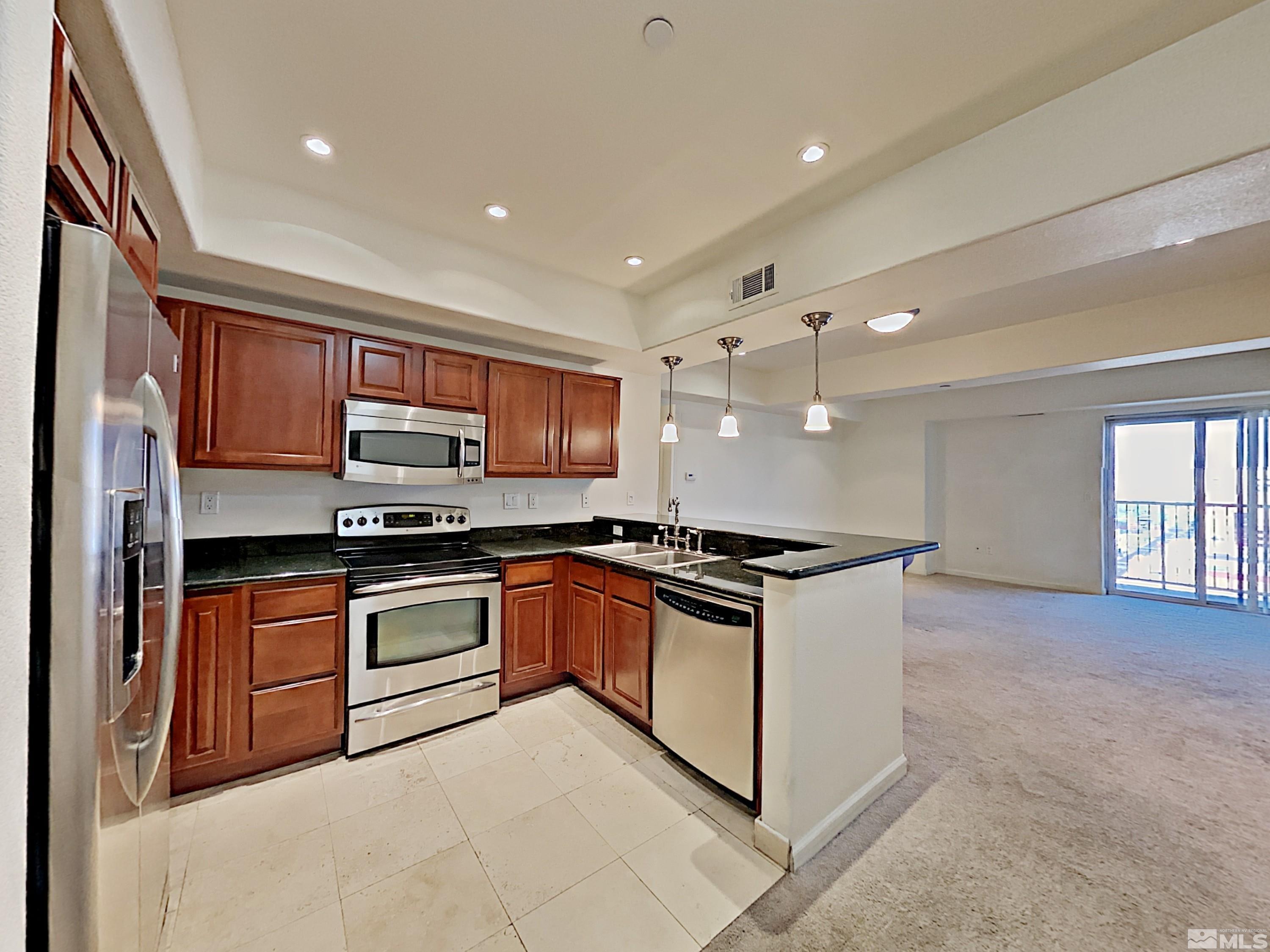 a kitchen with stainless steel appliances granite countertop a stove and a sink