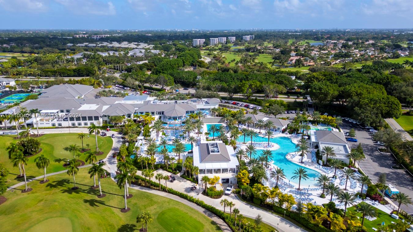 an aerial view of residential houses with outdoor space and swimming pool