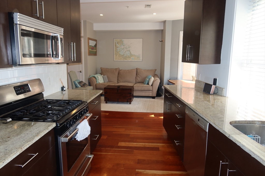 a kitchen with granite countertop a stove and a sink