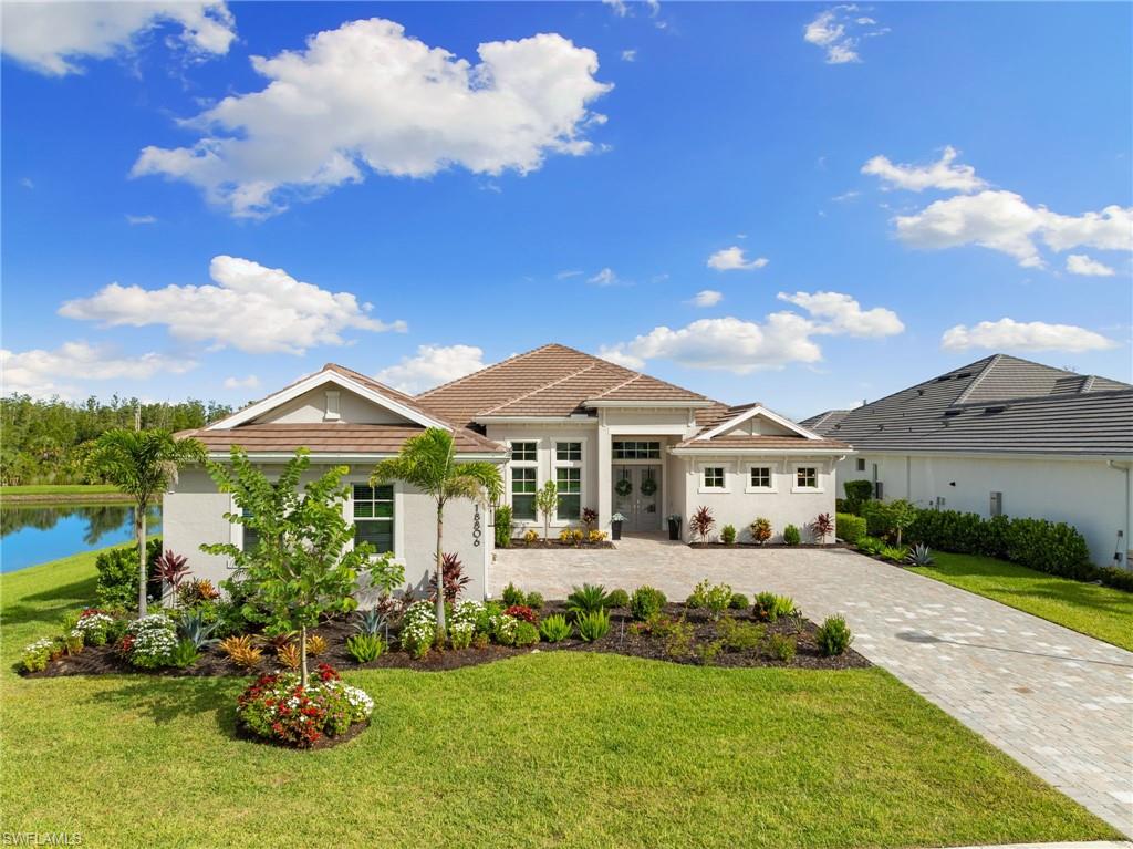 View of front facade featuring a side entry garage and a front lawn