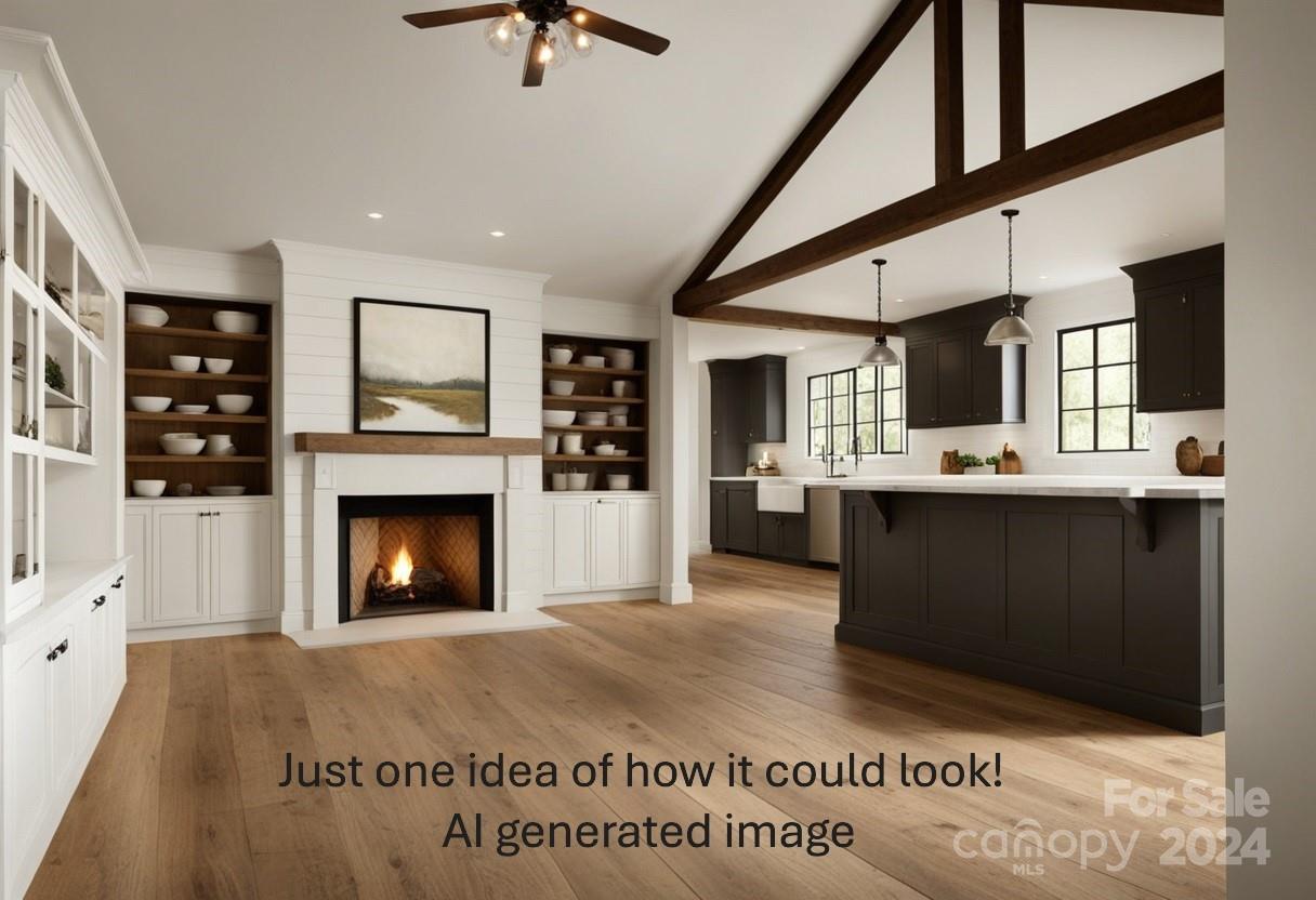 a living room with stainless steel appliances kitchen island furniture and a fireplace