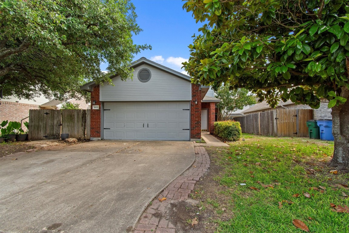 a view of a house with a yard and garage