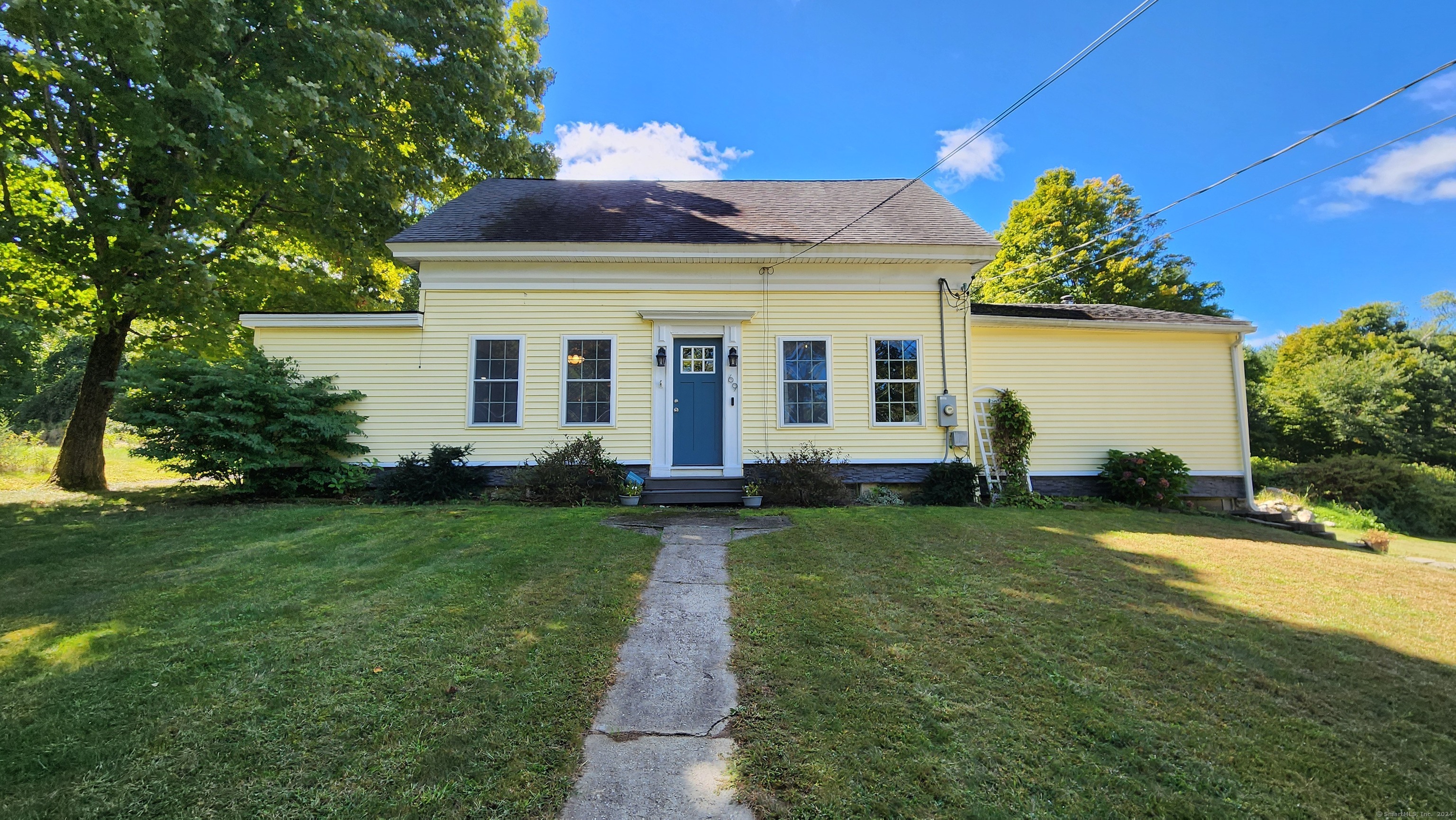 a front view of a house with a garden and yard