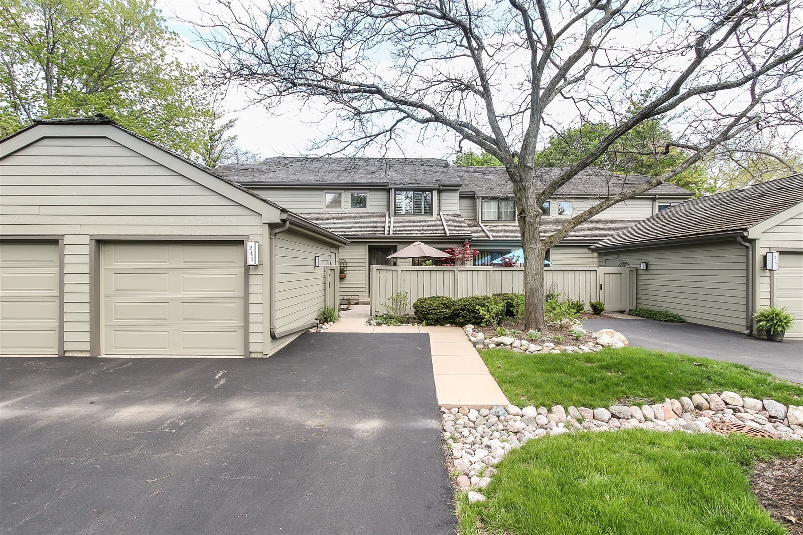 a view of a house with a yard and garage