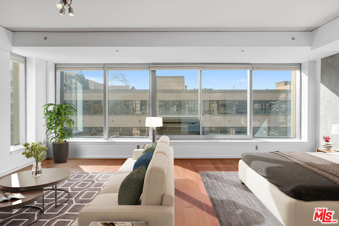 a living room with couch and a large window