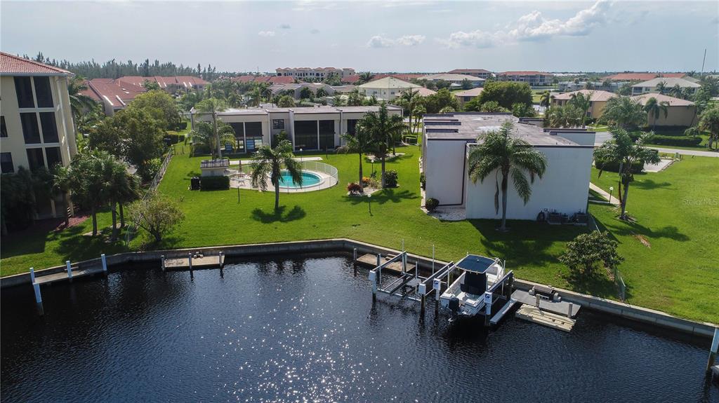 an aerial view of a house with a garden and lake view