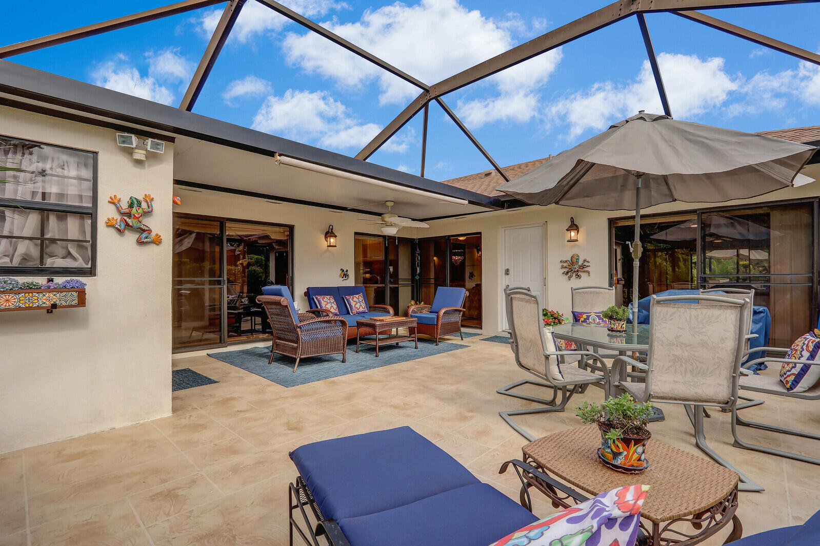 a view of a patio with table and chairs under an umbrella