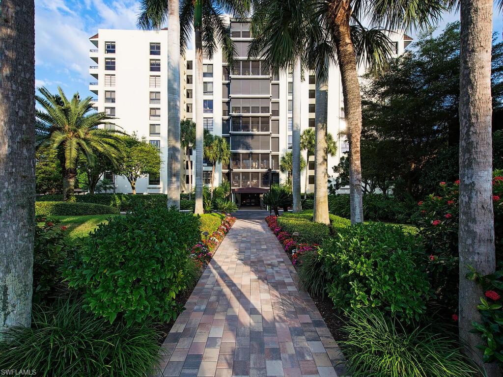 a front view of a multi story building with a yard