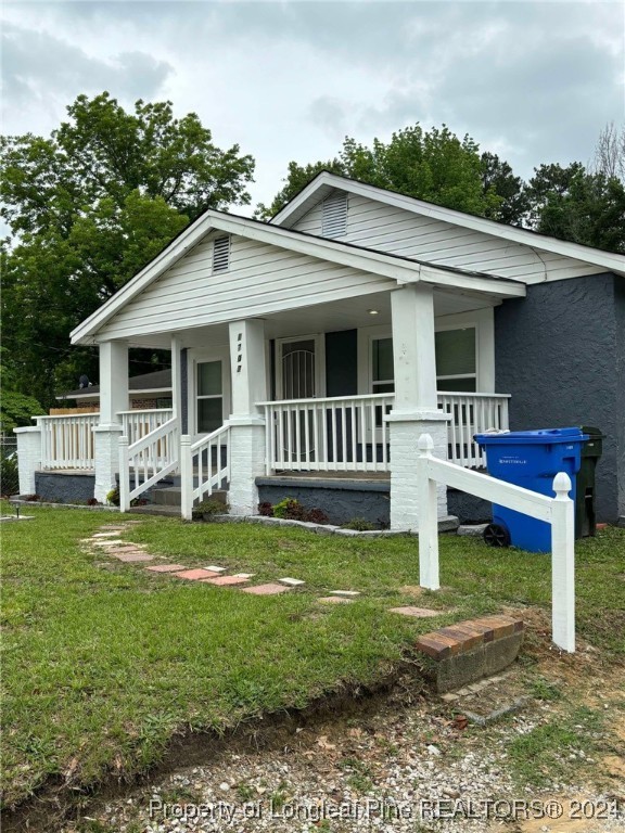 a front view of a house with a yard table and chairs