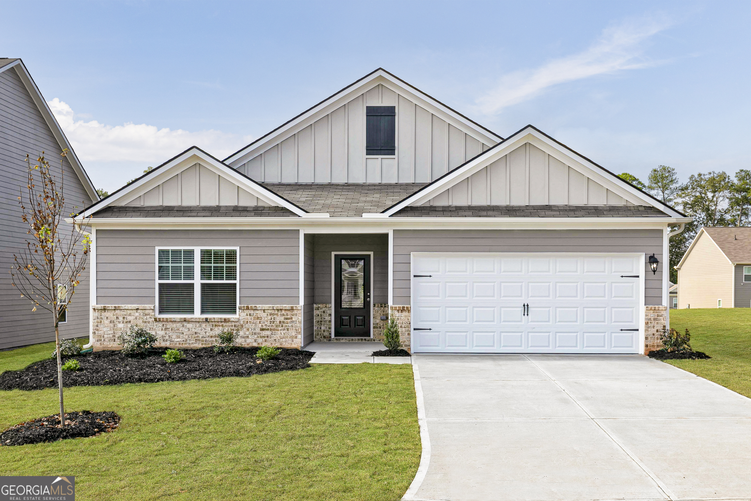 a front view of a house with a yard and garage