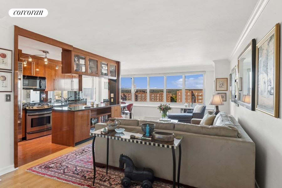 a living room with furniture and a kitchen