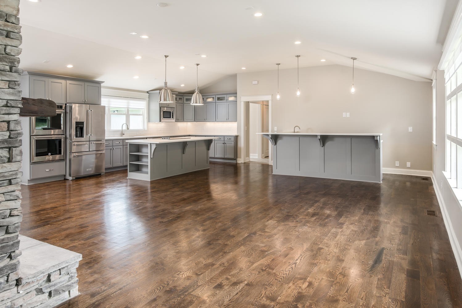 a large kitchen with a large counter top appliances and cabinets