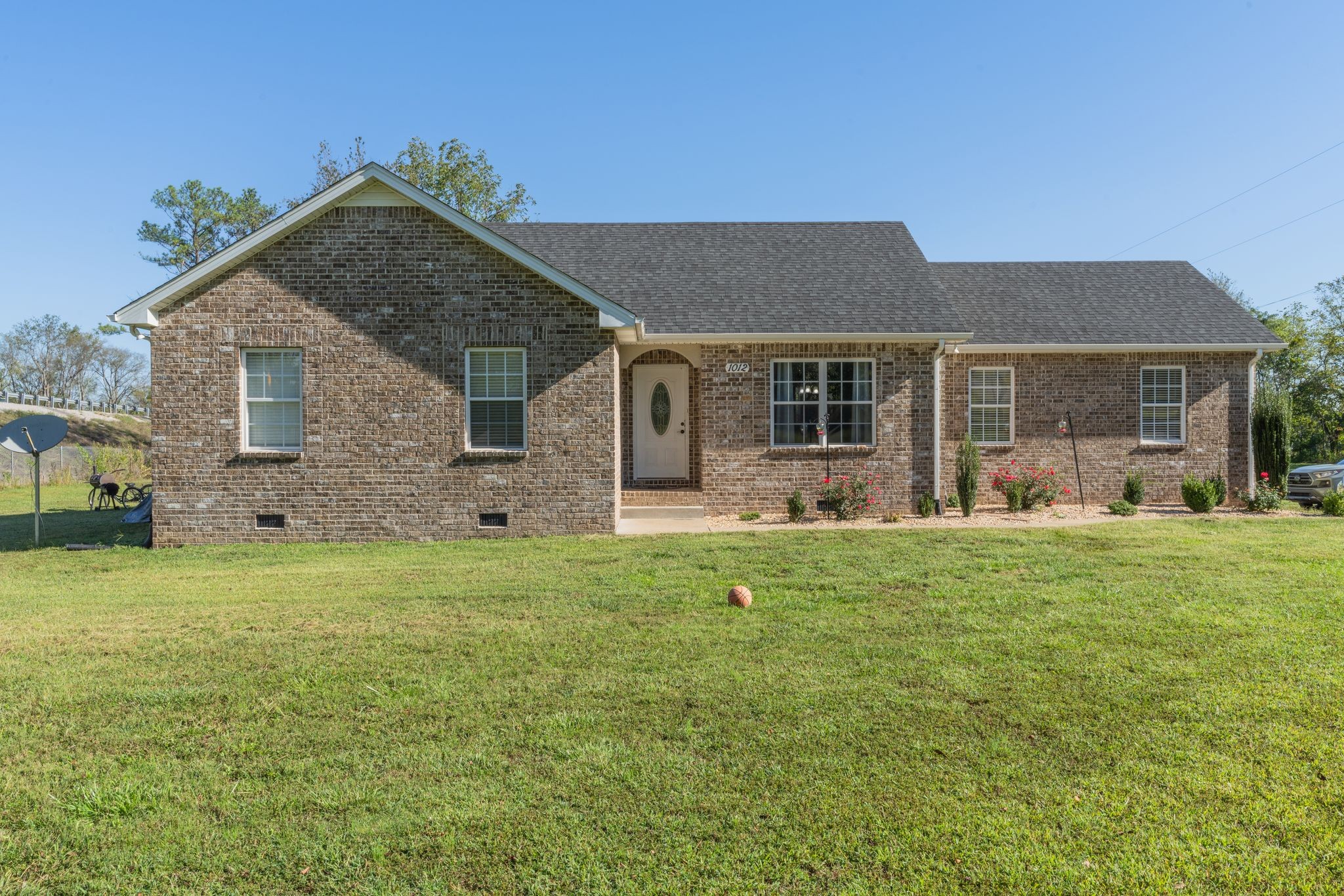 a front view of house with yard and green space