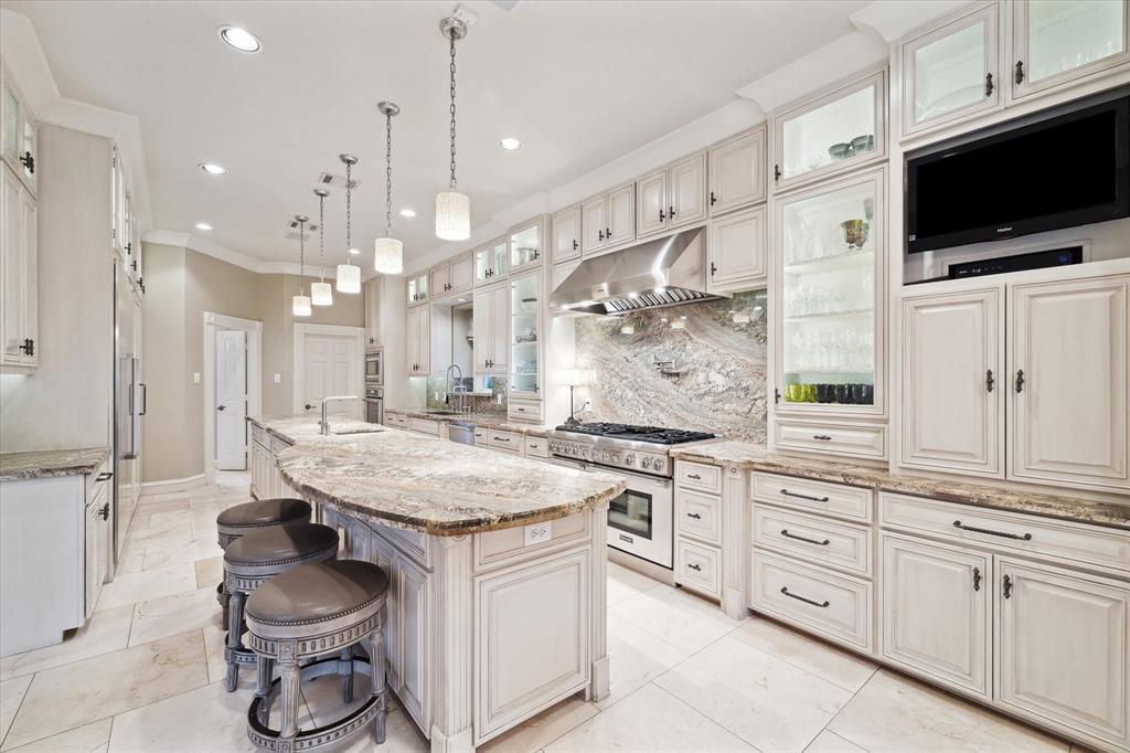 a kitchen with stainless steel appliances kitchen island granite countertop a stove a sink and a microwave