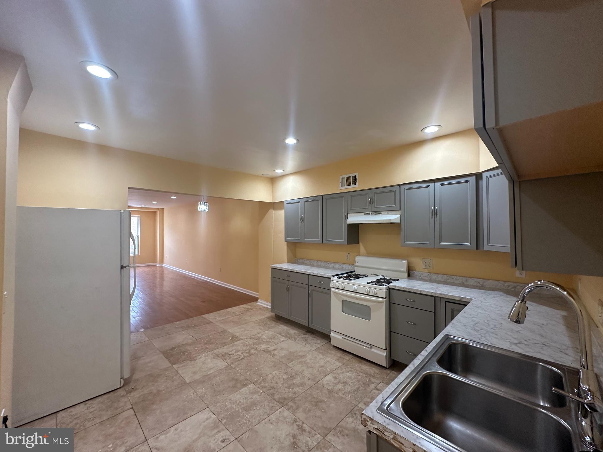 a kitchen that has a sink and a stove in it