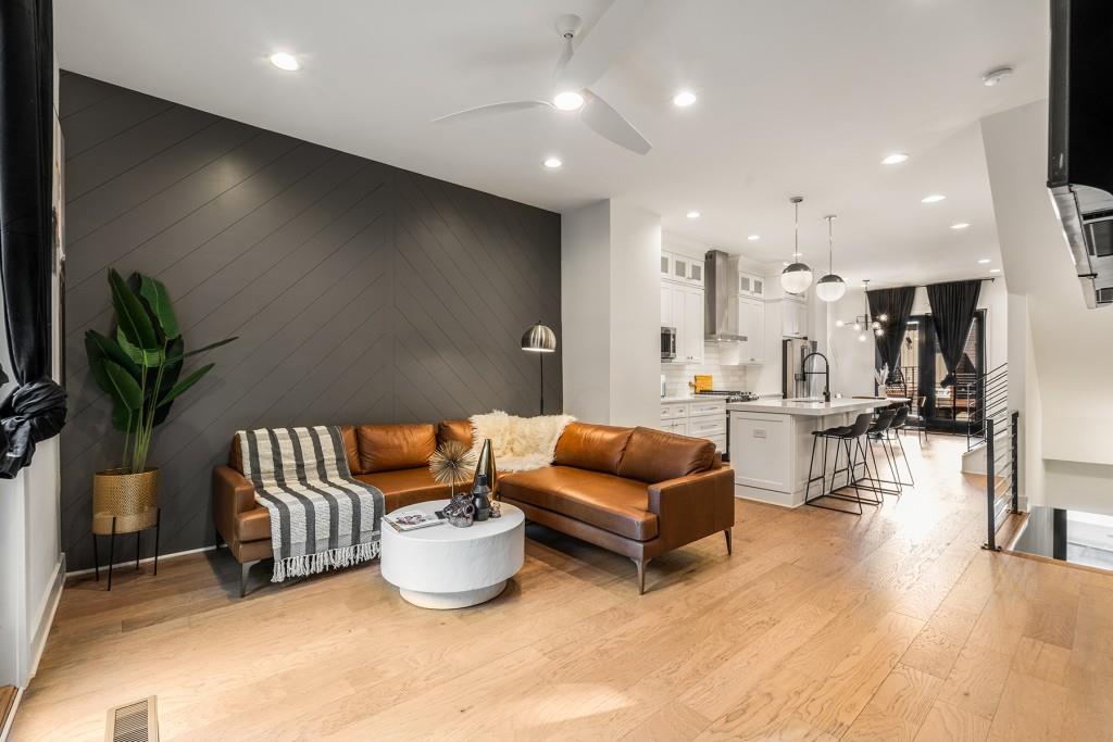 a living room with furniture and kitchen view