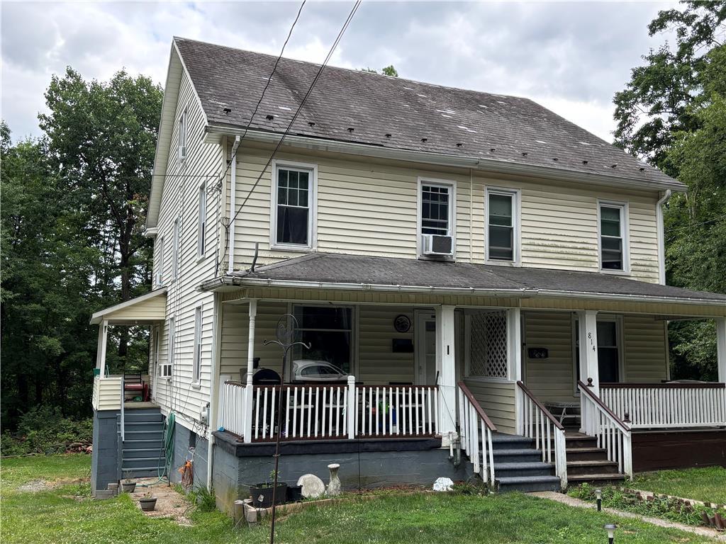 a view of a house with a yard and deck