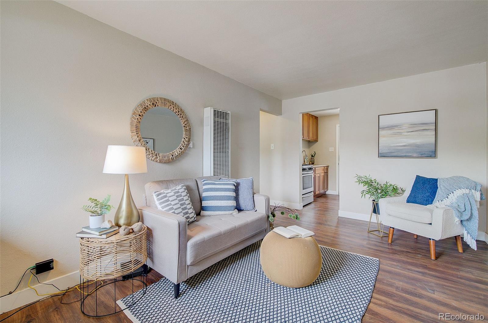 a living room with furniture and a wooden floor