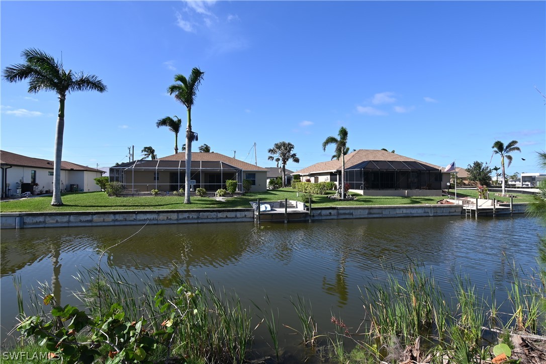 an aerial view of residential houses with outdoor space and lake view