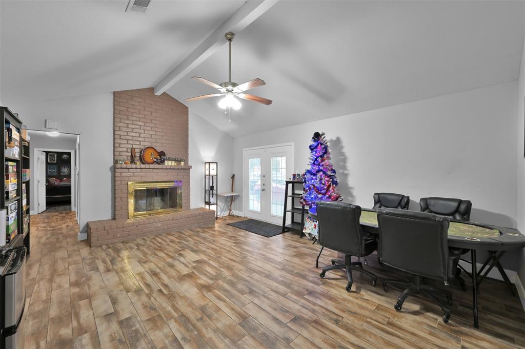 a view of a livingroom with furniture a chandelier fan and wooden floor