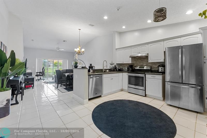 a kitchen with cabinets and stainless steel appliances