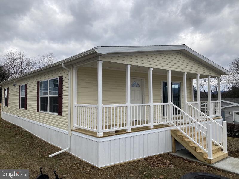 a view of a house with a wooden deck