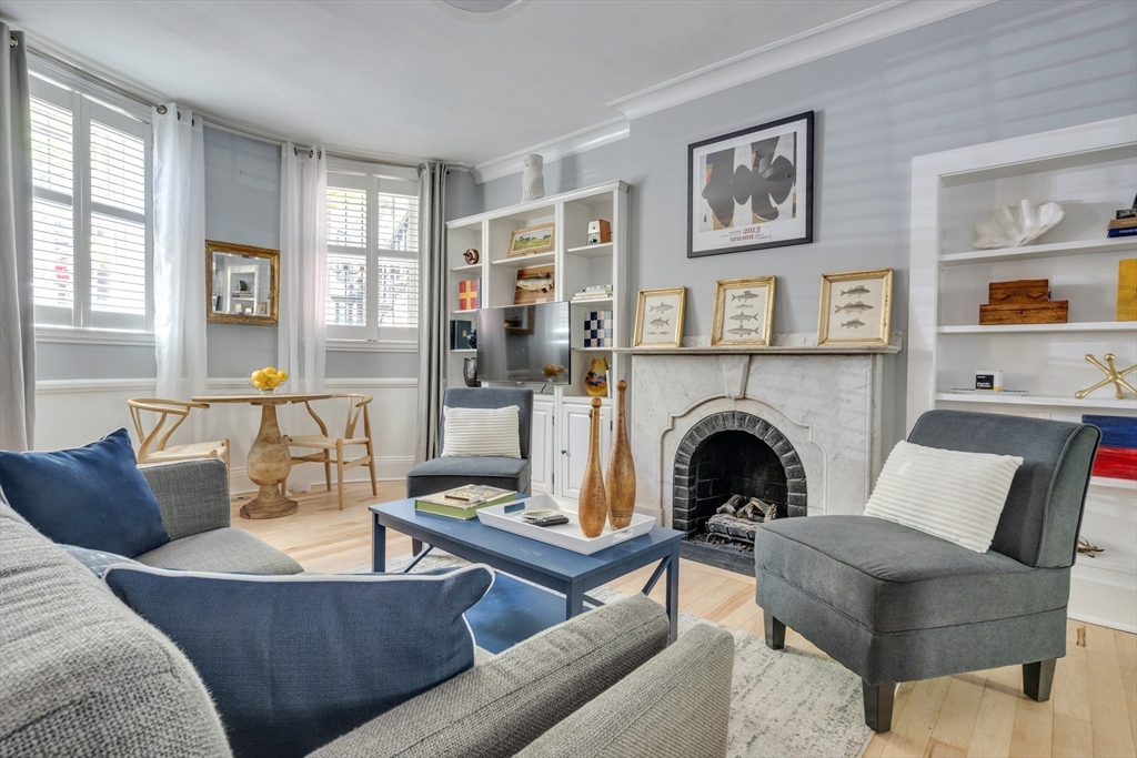 a living room with furniture and a fireplace