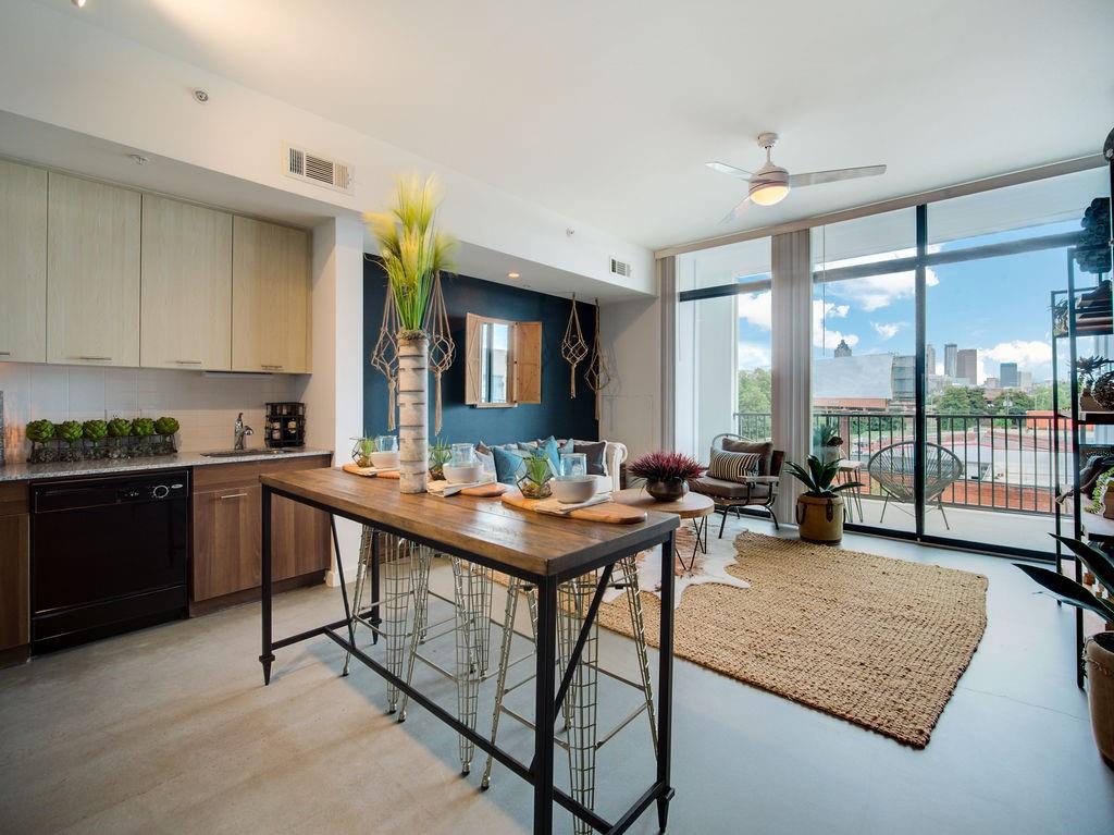 a kitchen with a table chairs and a counter top space