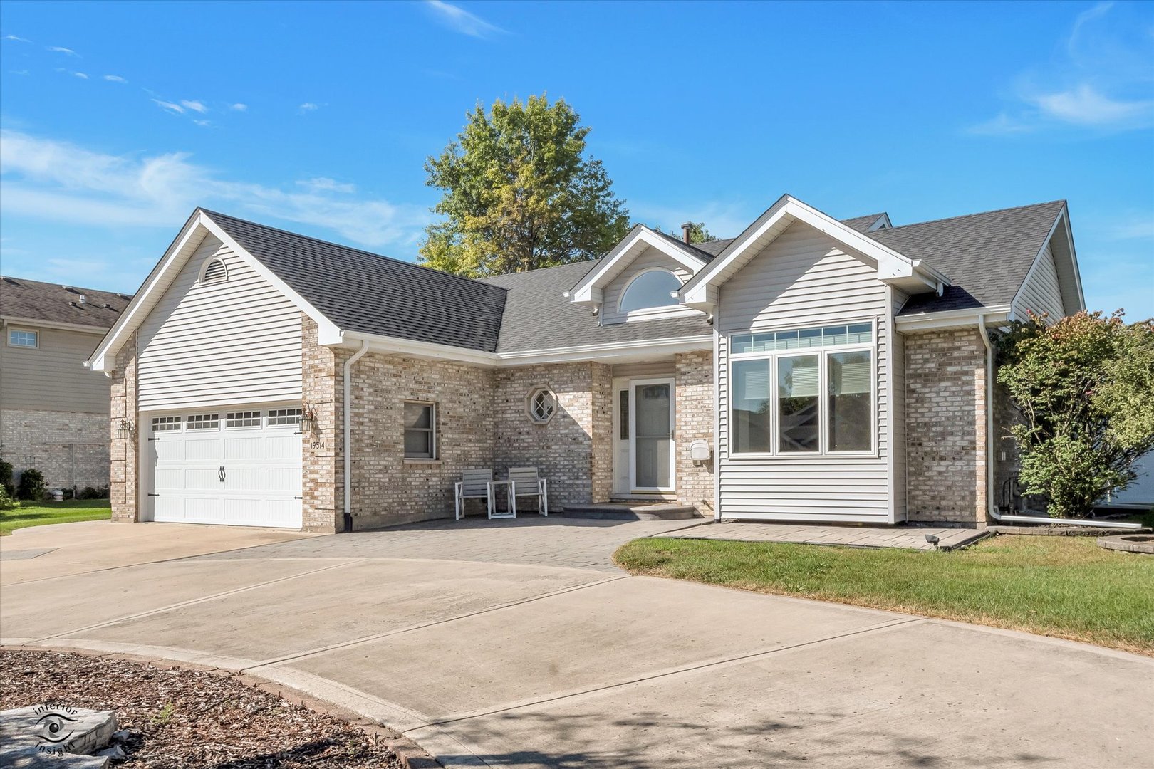 a view of the house with a backyard and a garage