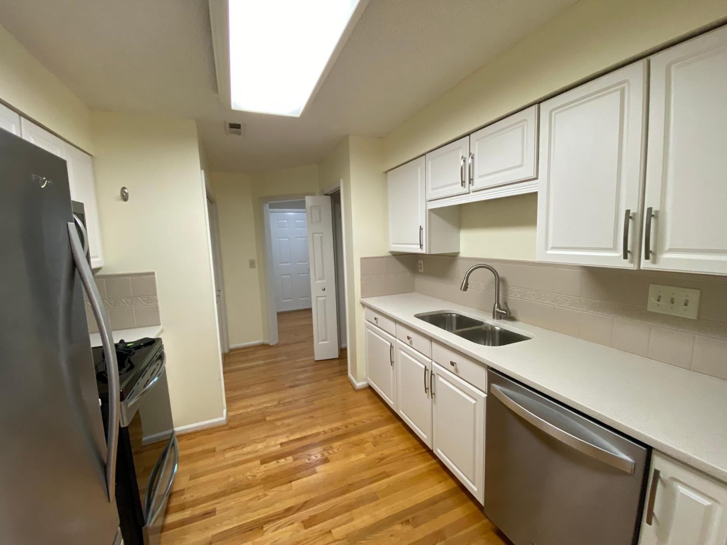 a kitchen with stainless steel appliances a sink stove and refrigerator