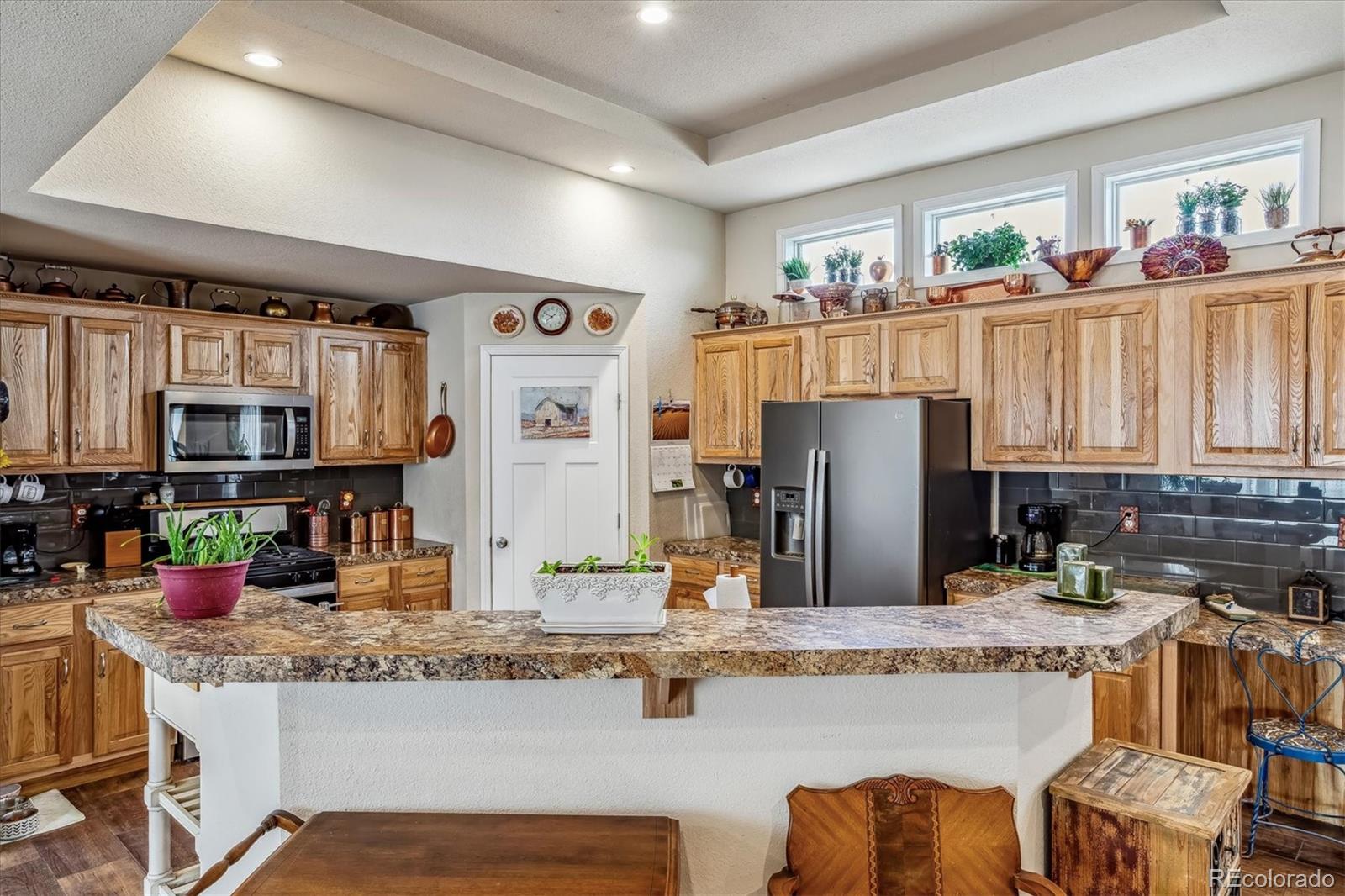 a kitchen with lots of counter top space and furniture