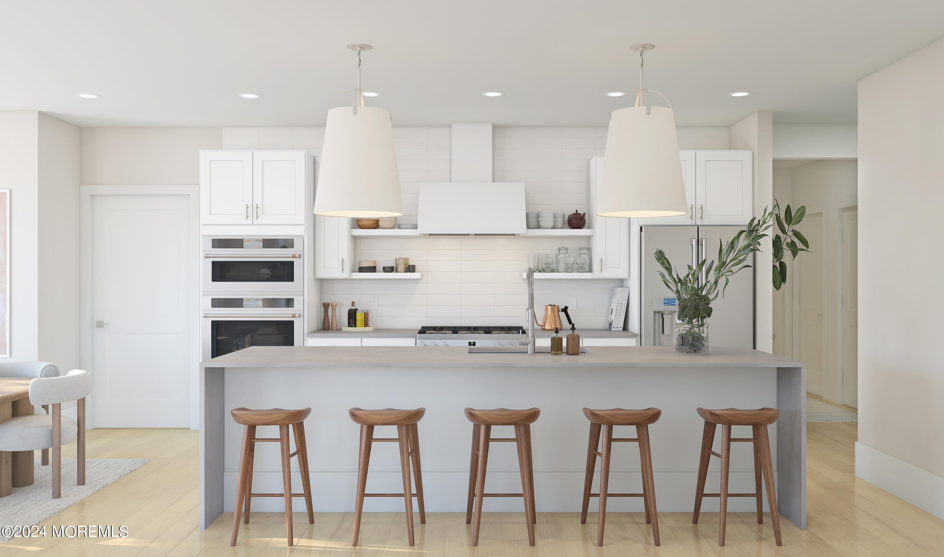 a kitchen with kitchen island cabinets and chairs in it