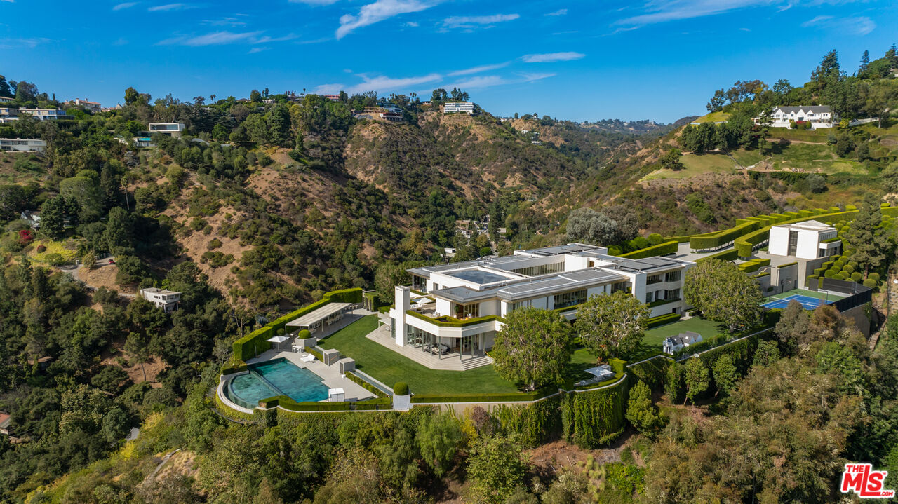 an aerial view of a house with a yard