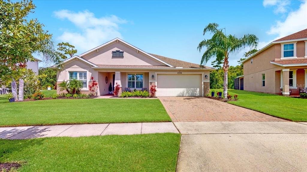 a front view of a house with a yard and garage