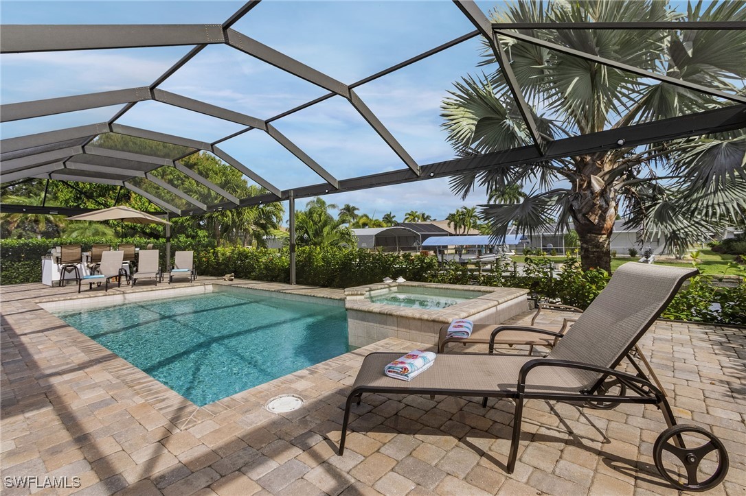 a view of a patio with a table and chairs under an umbrella