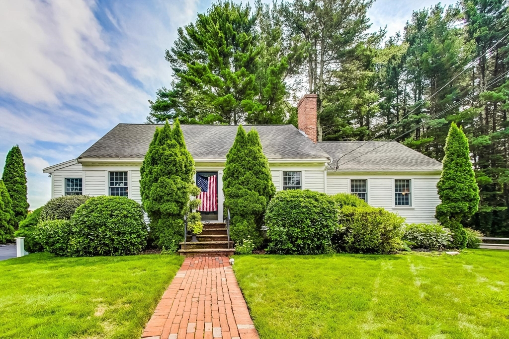 a front view of house with yard and green space