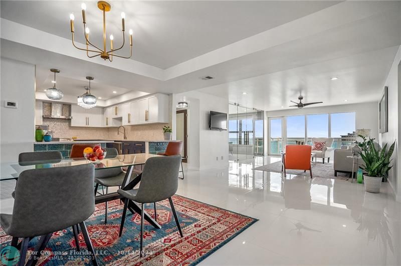 a living room with dining room and wooden floor