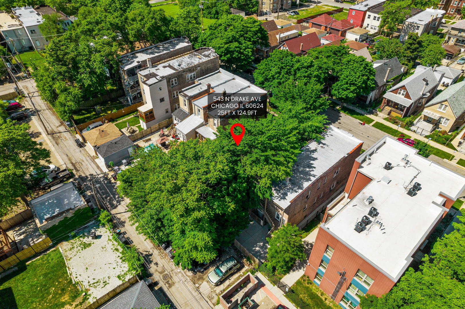 an aerial view of a house with a yard and outdoor seating