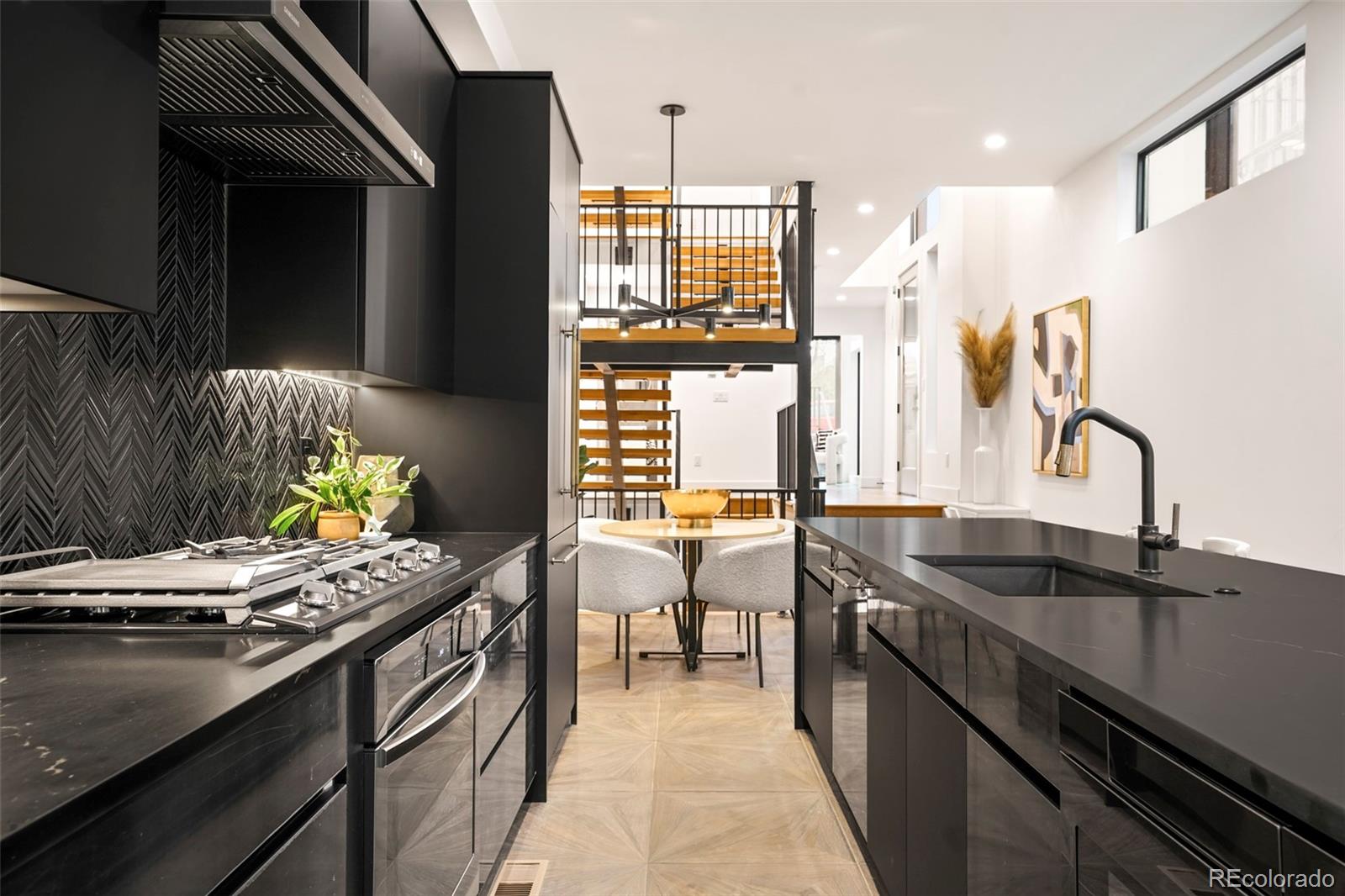 a kitchen with stainless steel appliances granite countertop a sink and a stove