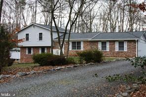 a front view of a house with a yard and pathway