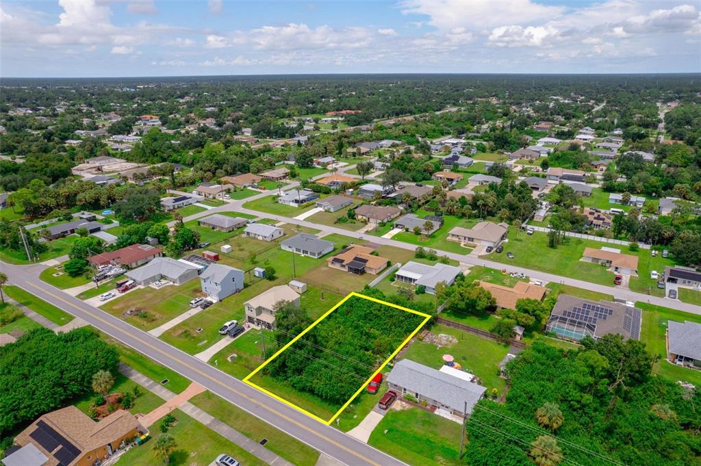 an aerial view of residential houses with outdoor space and street view