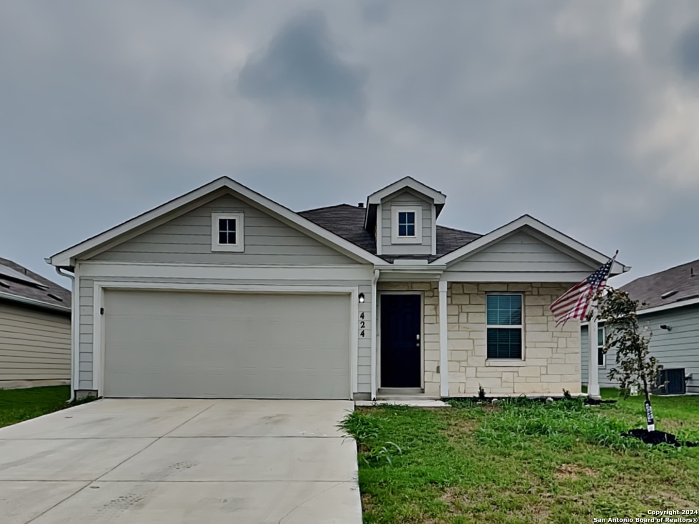 a front view of a house with a yard and garage